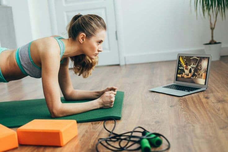 Person following a live streamed workout at home